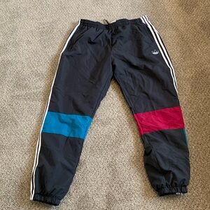 Here is a pair of adidas 3 stripe multi colored track pants size XL